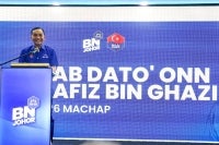 Johor BN chairman Datuk Onn Hafiz Ghazi announcing his candidacy for the N26 Machap seat during the Barisan Nasional Candidate Announcement Ceremony for the 16th Johor state election at the Johor State Umno Liaison Body in Johor Bahru, yesterday. - Photo by Bernama