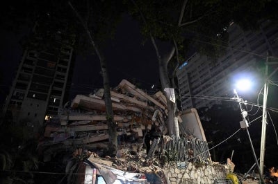 A collapsed building is seen following an earthquake in Caracas on June 24, 2026. Two earthquakes of magnitude 7.2 and 7.5 struck the same area of Venezuela on the evening of June 24, causing buildings to collapse, according to the United States Geological Survey and AFP journalists. - (Photo by FEDERICO PARRA / AFP)