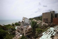 Collapsed buildings on a hillside overlooking the sea following an earthquake in Catia La Mar, La Guaira state, about 30 km northwest of Caracas. Photo by AFP