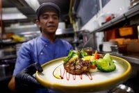 Chef Sabri Hassan showing a steak dish Sixty9 Islamic Steakhouse, recently. - Photo by Bernama