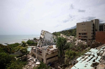 Collapsed buildings on a hillside overlooking the sea following an earthquake in Catia La Mar, La Guaira state, about 30 km northwest of Caracas. Photo by AFP