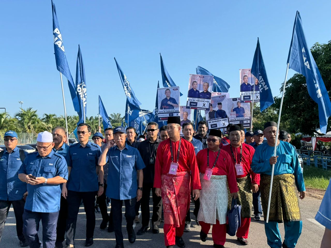 PN candidate Datuk Dr Sahruddin Jamal (in red baju melayu) accompanied by Bersatu President Tan Sri Muhyiddin Yassin at the Pagoh Sports Complex for the Bukit Kepong nomination centre. Photo by Norafiza Jaafar