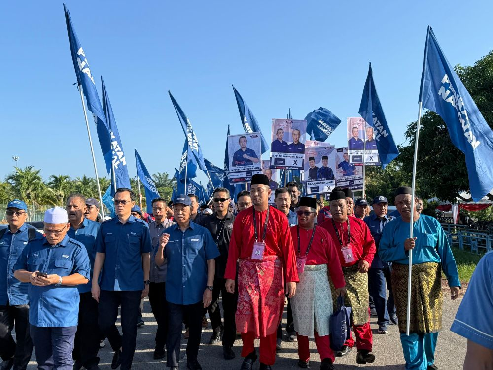 Muhyiddin (fourth from left) accompanies Bersatu-PN candidate Dr Sahruddin (fourth from right) for the Bukit Kepong state seat on Saturday.