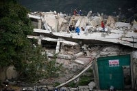 Rescuers search for possible victims at a collapsed building following twin earthquakes, in Los Corales, La Guaira state, some 40km northeast of Caracas, on June 27, 2026. - (Photo by FEDERICO PARRA / AFP)