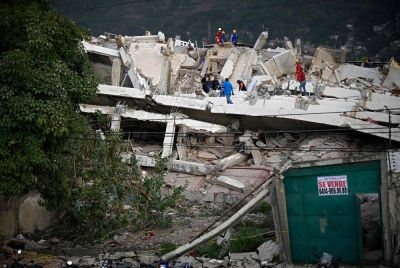 Rescuers search for possible victims at a collapsed building following twin earthquakes, in Los Corales, La Guaira state, some 40km northeast of Caracas, on June 27, 2026. - (Photo by FEDERICO PARRA / AFP)