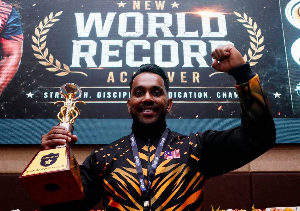 Fitness athlete K. Jey Prabakaran Thevar or better known as Dr Kjey dedicated his third world record-breaking feat in the 18-hour non-stop cardio and weightlifting event to his late father. Photo by Bernama