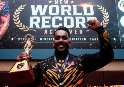 Fitness athlete K. Jey Prabakaran Thevar or better known as Dr Kjey dedicated his third world record-breaking feat in the 18-hour non-stop cardio and weightlifting event to his late father. Photo by Bernama