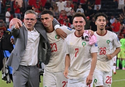 Morocco's head coach Mohamed Ouahbi celebrates with his players midfielder #23 Bilal El Khannouss, forward #07 Chemsdine Talbi and defender #26 Anass Salah-Eddine after winning the penalty shootout. Photo by AFP