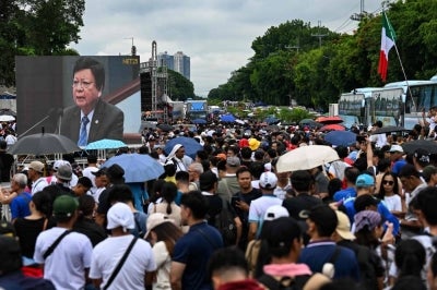 Thousands of members of a powerful Philippine religious sect rallied in Manila, snarling rush hour traffic for kilometres in every direction as they protested the looming arrest of a senator and church member. - (Photo by JAM STA ROSA / AFP)
