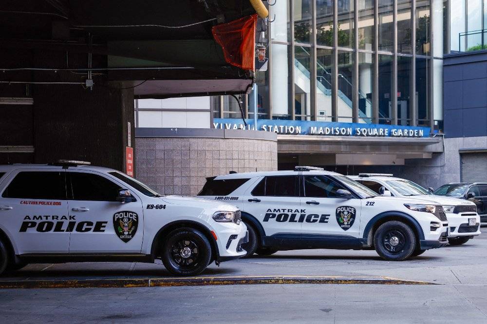 Police cruisers of the passenger railroad company Amtrak are parked outside the Madison Square Garden access to Penn Station in New York. Photo by AFP
