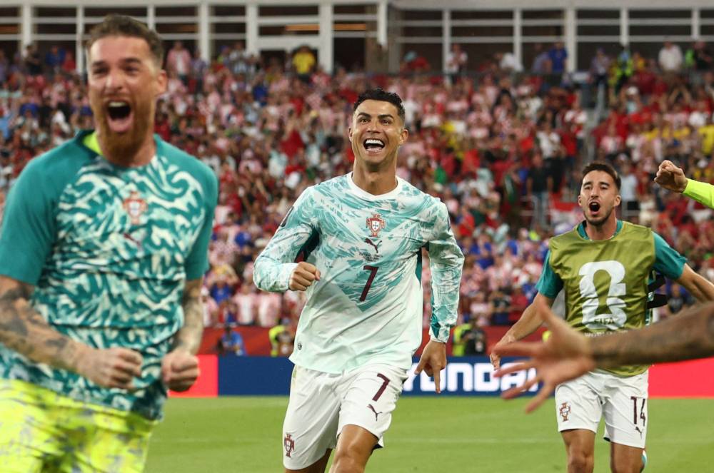 Portugal's forward #07 Cristiano Ronaldo celebrates with teammates after his team scored their second goal during the 2026 World Cup round of 32 football match between Portugal and Croatia at the Toronto Stadium in Toronto on July 2, 2026. Photo by Cole Burston/AFP