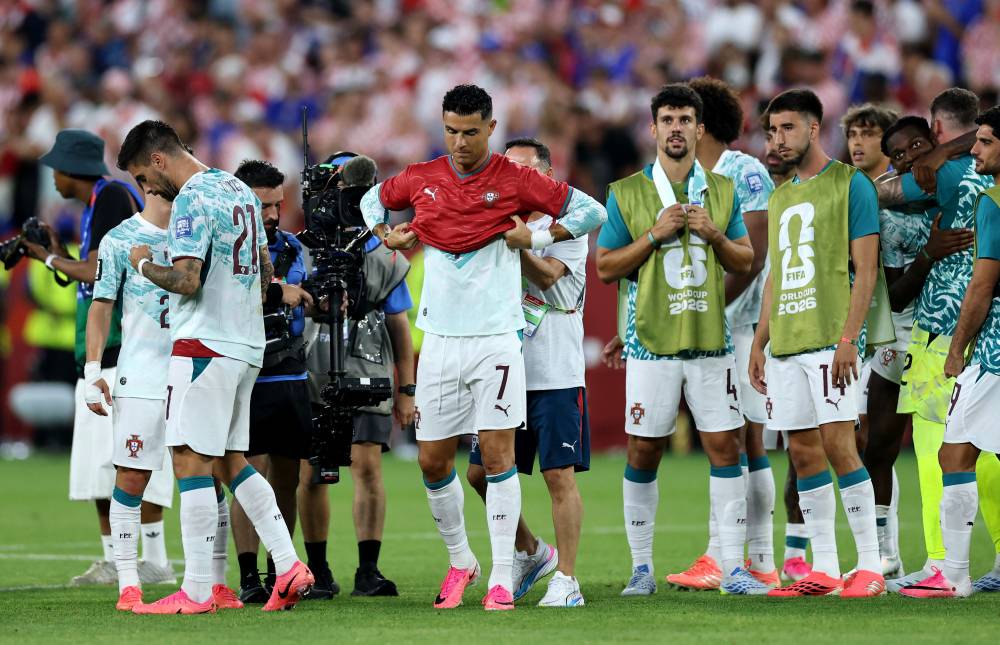 Cristiano Ronaldo #7 of Portugal celebrates with a shirt in commemoration of late teammate Diogo Jota after the 2-1 win during the FIFA World Cup 2026 Round of 32 match between Portugal and Croatia at Toronto Stadium. Photo by Buda Mendes/Getty Images via AFP