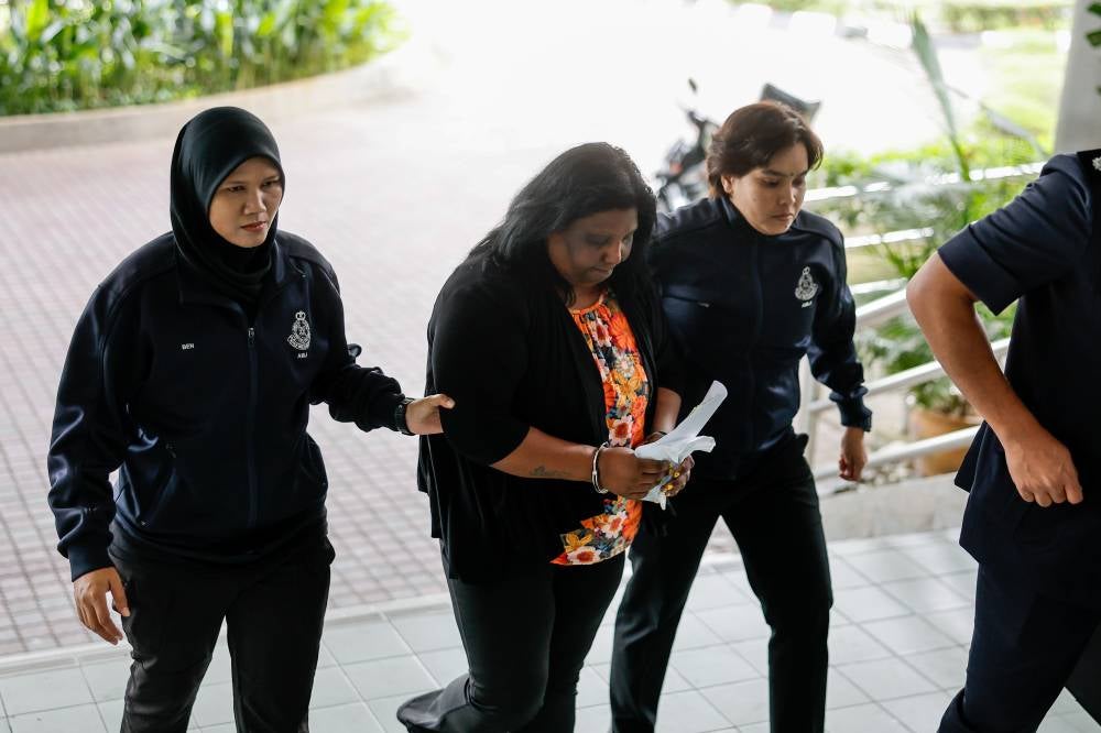 Former kindergarten teacher A. Venmani, 50, pleaded not guilty in the Sessions Court today to three counts of money laundering involving RM133,550 in cash and gold jewellery allegedly linked to a scheme promising to facilitate a child's relocation to New Zealand last year. - Photo by Bernama