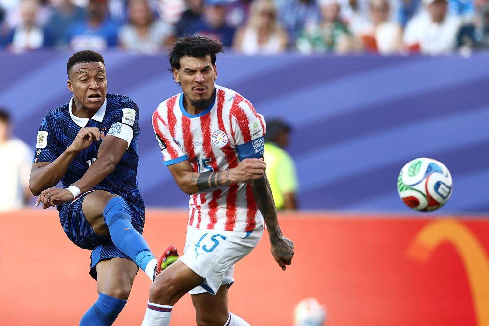 France's forward #10 Kylian Mbappe and Paraguay's defender #15 Gustavo Gomez fight for the ball during the 2026 World Cup round of 16 football match between Paraguay and France at the Philadelphia Stadium in Philadelphia. Photo by AFP