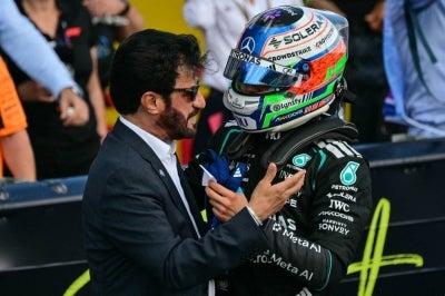 FIA president Mohammed Ben Sulayem (left) congratulating Mercedes driver Kimi Antonelli on his pole position in qualifying for the Silverstone GP, July 4th(Photo by Andrej ISAKOVIC / AFP)