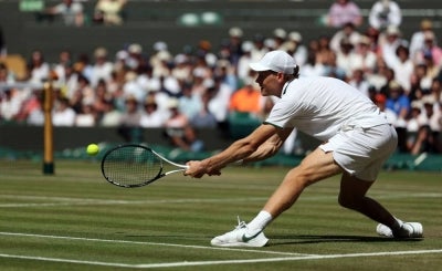 Italy's Jannik Sinner in action against Germany's Jan-Lennard Struff during their men's singles quarter-final tennis match on the ninth day of the 2026 Wimbledon Championships at The All England Lawn Tennis and Croquet Club in Wimbledon, southwest London, on July 7, 2026. (Photo by Adrian Dennis / AFP) / RESTRICTED TO EDITORIAL USE