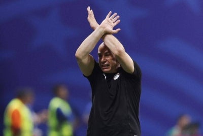 Egypt head coach Hossam Hassan made FIFA’s official “X” anti-racism gesture during the World Cup Round of 16 match against Argentina national football team at Atlanta Stadium on July 7. (Photo by Buda Mendes / AFP)