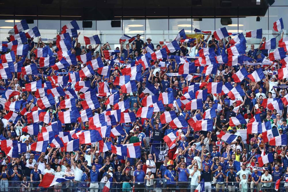 Tragedy strikes France's World Cup celebrations as a 17-year-old girl dies falling from a truck (Photo by CHARLY TRIBALLEAU / AFP)
