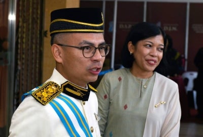 Communications Minister Datuk Seri Fahmi Fadzil (left) with his wife Datin Seri Azrinas Puteri Mohamed Mahyuddin at the 2026 Investiture Ceremony for Penang State Orders, Decorations and Medals in conjunction with the Governor's 85th birthday today. - BERNAMA photo
