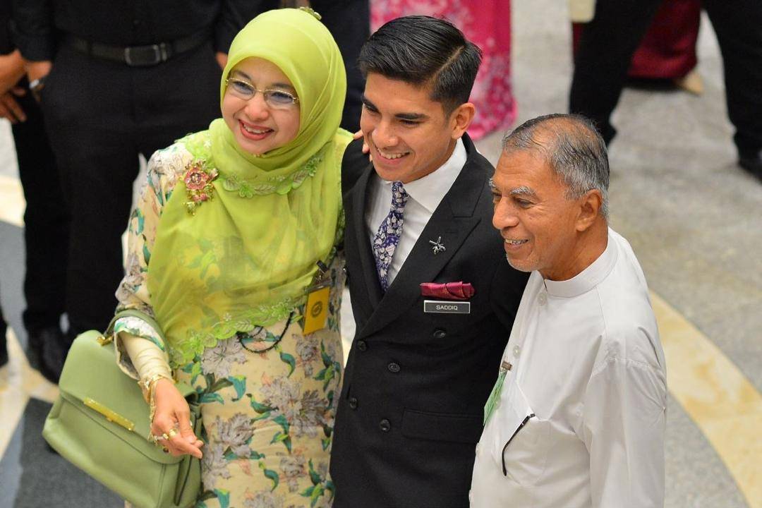 Syed Saddiq Syed Abdul Rahman with his mother Sharifah Mahani Syed Abdul Aziz and father Syed Abdul Rahman Abdullah Al-Sagoff at the Palace of Justice after the Federal Court acquitted and discharged the Muar MP of corruption charges linked to funds belonging to Armada. - Photo by ASRIL ASWANDI SHUKOR