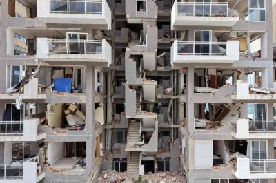 Aerial view of apartments exposed after part of a residential building collapsed in Caraballeda, La Guaira state, Venezuela, on July 12, 2026, following twin earthquakes that struck the region. - (Photo by ZINA DESMAZES / AFP)