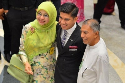 Syed Saddiq Syed Abdul Rahman with his mother Sharifah Mahani Syed Abdul Aziz and father Syed Abdul Rahman Abdullah Al-Sagoff at the Palace of Justice after the Federal Court acquitted and discharged the Muar MP of corruption charges linked to funds belonging to Armada. - Photo by ASRIL ASWANDI SHUKOR