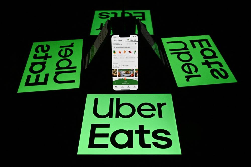 United States (US) ride-hailing giant Uber on Thursday announced a multibillion-euro deal to acquire Germany's Delivery Hero as it seeks to expand its presence in the global food delivery market. (Photo by Lionel BONAVENTURE / AFP)