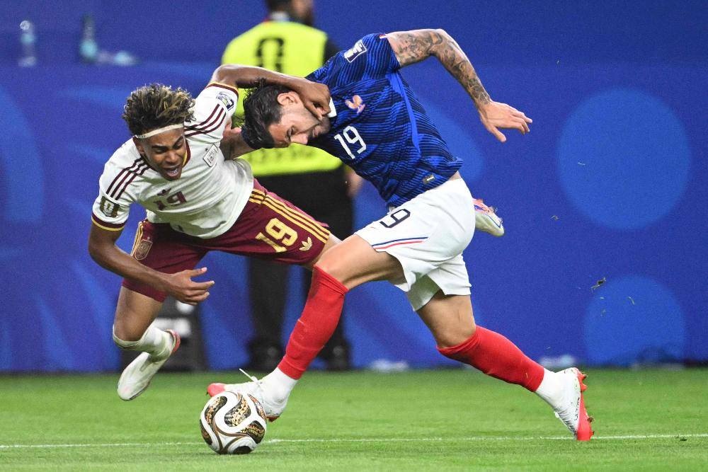 Spain's forward #19 Lamine Yamal (L) and France's defender #19 Theo Hernandez fight for the ball during the 2026 World Cup football tournament semi-final match between France and Spain at the Dallas Stadium. Photo by Mauro Pimentel/AFP
