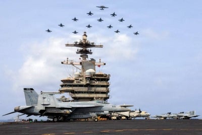 This US Navy handout photo released on July 15, 2026 and taken on June 30 by US Central Command Public Affairs shows the Carrier Air Wing (CVW) 7 flying in formation over the USS George H.W. Bush (CVN 77) in the Arabian Sea. The US launched a wave of strikes against Iran on July 15, after it reimposed a naval blockade in a return to war between the two foes. - (Photo by US NAVY / AFP)