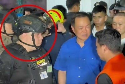 The man, identified as Chitpong Khattapong, was seen near Anutin at Rong Beer Na Lad Phrao, a bar in the Chatuchak area where a fire killed dozens of people. Photo: Thairath TV