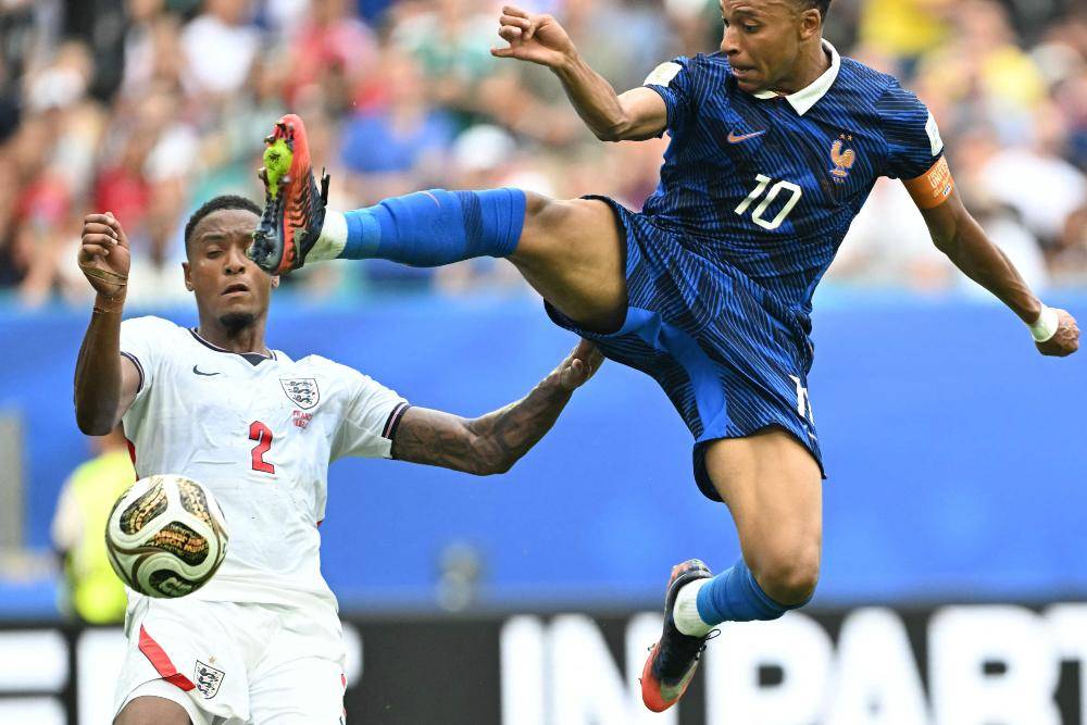 England's defender #02 Ezri Konsa and France's forward #10 Kylian Mbappe fight for the ball during the 2026 World Cup football tournament third-place match between France and England at the Miami Stadium. Photo by AFP