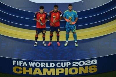 Spain's defender #22 Pau Cubarsi, Spain's midfielder #16 Rodri and Spain's goalkeeper #23 Unai Simon celebrate with their trophies after the 2026 World Cup football tournament final match between Spain and Argentina. Photo by AFP