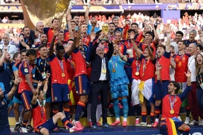 Luis de la Fuente, Head Coach of Spain, lifts the FIFA World Cup Winner's Trophy after the team's victory following the FIFA World Cup 2026 Final match between Spain and Argentina at New York New Jersey Stadium. Photo by AFP