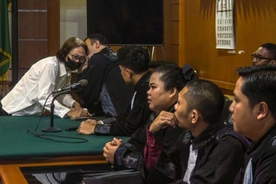 A defendant speaks to her lawyers during a trial in a baby trafficking case at the Bandung District Court in Bandung, West Java. Photo by Timur Matahari/AFP