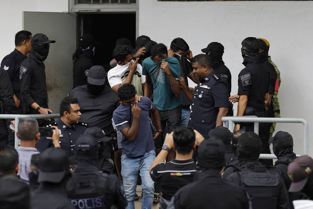Eleven men were brought before the Sepang Sessions Court today on charges of being members of an organised crime syndicate known as "Vinod Gang." - Photo by Bernama