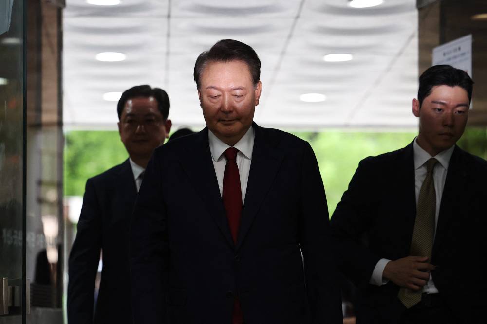 South Korea's former impeached president Yoon Suk Yeol (C) (Photo by KIM HONG-JI / POOL / AFP)