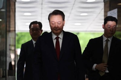 South Korea's former impeached president Yoon Suk Yeol (C) (Photo by KIM HONG-JI / POOL / AFP)