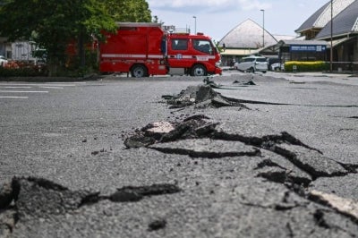 A cracked road is seen in Hikawa, Kumamoto Prefecture on July 30, 2026, after an earthquake struck southwestern Japan on July 28. - (Photo by PHILIP FONG / AFP)