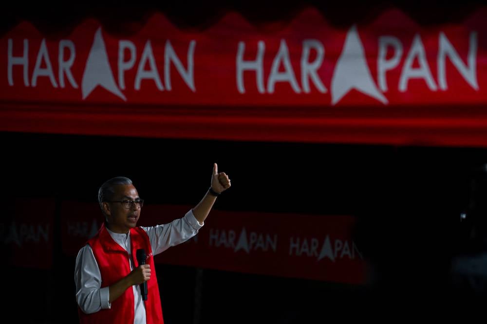 Communications Minister and PH communications director Datuk Seri Fahmi Fadzil (centre) delivering his speech while assisting PH candidate Mohd Hanis Alimin in his campaign during the DUN Senaling Grand Finale Ceramah Programme at Warung Mee Bandung US on Thursday. - Photo by Bernama