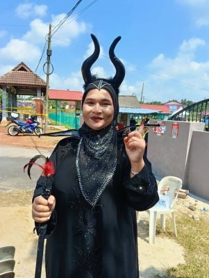 Roslina Janian, 46, arrived to cast her vote in the Negeri Sembilan state election wearing a Maleficent-inspired outfit, complete with a black robe, horned headpiece and a staff.