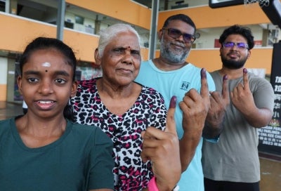 A family of four: D. Chandru, 49, (second, right) present to vote with his two children, C. Vishvar, 20, (right), C. Vikashni, 19, (left), and his mother K. Rasamma, 72, (second, left) at the 16th Negeri Sembilan State Election polling centre at Sekolah Jenis Kebangsaan Cina Kelpin, Jalan Tok Ungku, Taman Ujong today. BERNAMA photo