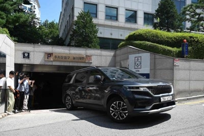 A police vehicle drives out of the Korea Football Association (KFA) House in Seoul on August 6, 2026. Police raided South Korea's football association on August 6, as part of an investigation into the appointment of the coach in charge during their dismal World Cup campaign. (Photo by GREG BAKER / AFP)