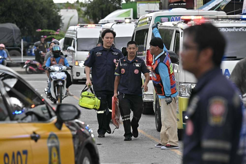 Emergency responders gather outside a school following a shooting in Bang Kruai district, Nonthaburi province, north of Thailand's capital Bangkok. Photo by Lillian Suwanrumpha/AFP