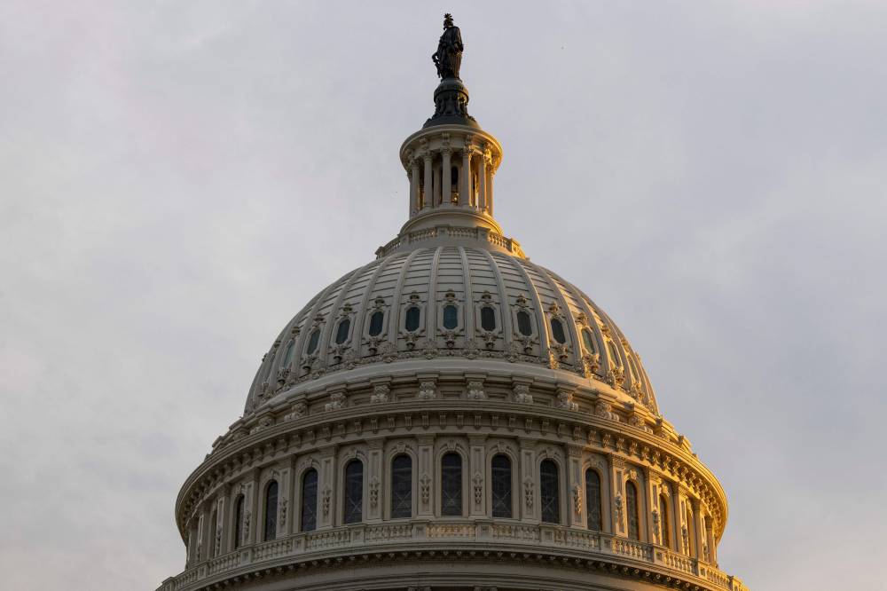 The sun sets behind the the U.S. Capitol Building. (Photo by Finn Gomez / GETTY IMAGES NORTH AMERICA / Getty Images via AFP)