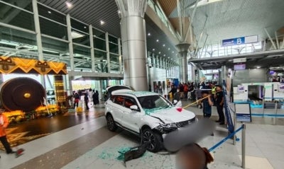 Failure to shift the gear into the "P” (Park) position while attempting to switch drivers caused a sports utility vehicle (SUV) to crash into the glass doors of the Kota Kinabalu International Airport (KKIA) Departure Hall last Friday. Photo: Social media