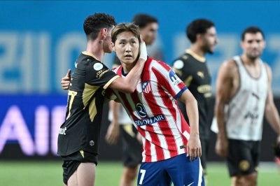 Manchester City Phil Foden (L) embraces Atletico Madrid Lee Kang-in after their exhibition football match at Seoul World Cup Stadium in Seoul on August 9, 2026. (Photo by GREG BAKER / AFP)