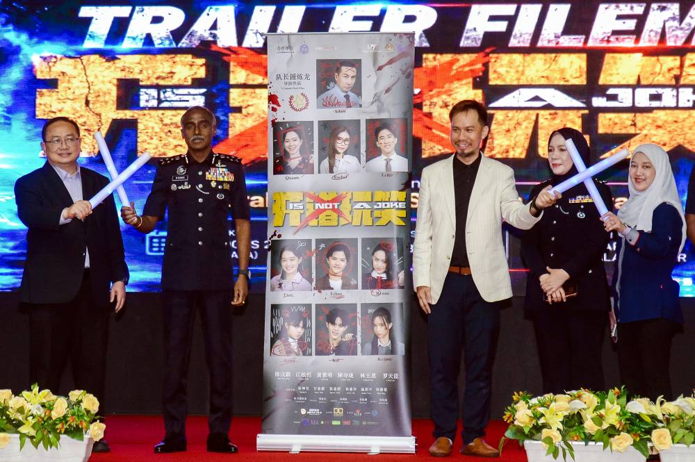 Bukit Aman Criminal Investigation Department director Datuk M. Kumar (second, left) officiated the launch of the film "Is Not A Joke” at the Police Training Centre (Pulapol) Kuala Lumpur today.
Also present was the director of the film "Is Not A Joke”, Captain Denil (third, right). - BERNAMA photo