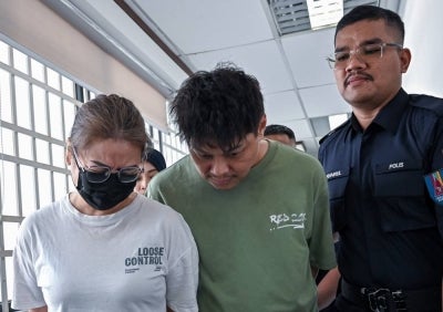 Married couple Teoh Wai Loon, 44, and Lim Suk Pei, 38, were charged at the Ipoh magistrate’s court today with trafficking 480.6 grammes of Methylenedioxymethamphetamine (MDMA) last week. - Photo by Bernama