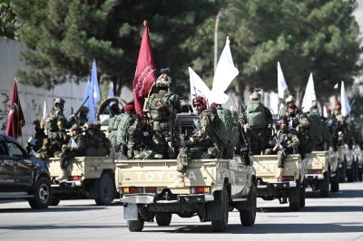 A convoy of Taliban security personnel is seen near the former US Embassy in Kabul on August 15, 2026 as they celebrate the fifth anniversary of the Taliban government's return to power. The Taliban government celebrates five years of ruling Afghanistan on August 15, with the authorities hailing their country's "freedom" and security, while critics decry tightening restrictions in all areas of daily life. (Photo by Wakil Kohsar / AFP)