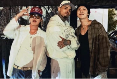BTS members J-hope (left) and RM (right) posing with Chris Brown (centre) and the latter's concert in Toronto, Canada.